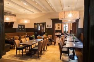 a restaurant with tables and chairs in a room at Hotel zur Krone in Gescher