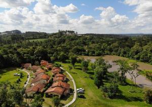 an aerial view of a house with a river at Ózera Hotel Fazenda in Prudentópolis