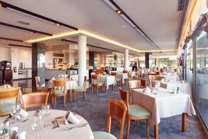 a dining room with white tables and chairs at Bonanza Park Hotel by Olivia Hotels Collection in Illetas