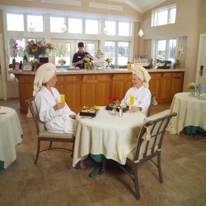 two women sitting at a table in a kitchen at Stoweflake Mountain Resort & Spa in Stowe
