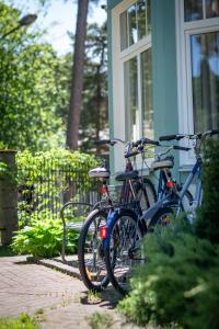 two bikes are parked outside of a house at Parus Boutique Hotel in Jūrmala