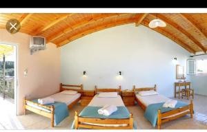 a bedroom with two beds and a balcony at Apollo in Kavos