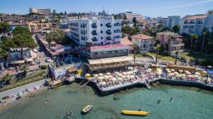 an aerial view of a city with people in the water at Marti Prime Beach Hotel in Kuşadası