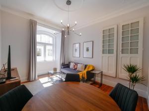 a living room with a table and a couch at Fanqueiros 196 - Center City Apt in Lisbon
