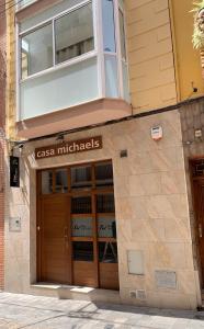 a building with a sign on the front of it at Hostal Casa Michaels in Móra d'Ebre