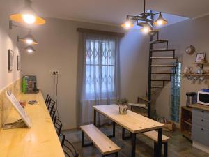a kitchen with a table and a wooden table and stairs at Hostel 47 in Batumi +23 photos