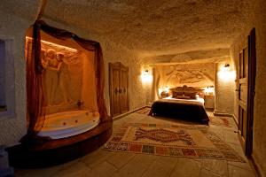 a bedroom with a bed and a bath tub at Miras Hotel in Göreme