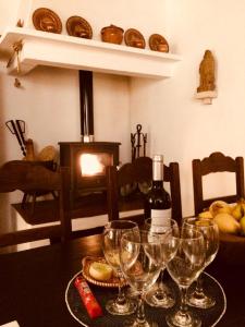 einen Tisch mit Weingläsern und eine Flasche Wein in der Unterkunft Casa da Galega in Golegã