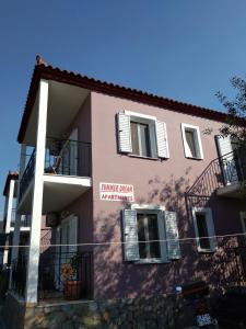 a pink building with a sign on the side of it at Summer Dream in Anaxos