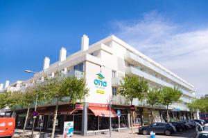 a large white building with a cico sign on it at Aparthotel Ona Palamós in Palamós