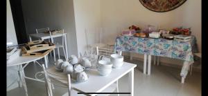 a room with a table and chairs with dishes on it at La casa del Moro in Sabaudia +32 photos