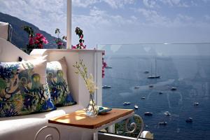 a balcony with a view of the water with boats at Hotel Montemare in Positano