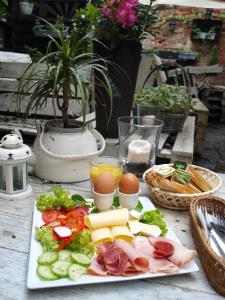 a plate of food with eggs and vegetables on a table at Rainbow Apartments 2 in Krakow