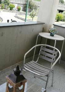 a chair sitting next to a table on a balcony at B&B Sweet Home Two Steps From The Ruins... in Pompei