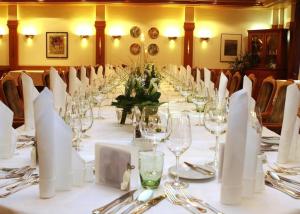 a long table with glasses and napkins on it at Hotel-Restaurant Adler in Lahr