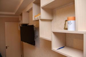 a cabinet with a cup and a pen in a room at Pearl apartment in Kutaisi in Kutaisi