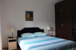 a bedroom with a bed with two pillows on it at Casa Agava Becici in Bečići
