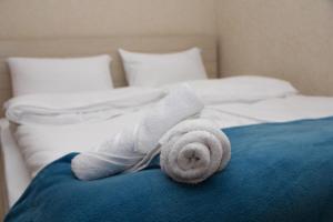 a stuffed animal is laying on a bed at Pearl apartment in Kutaisi in Kutaisi