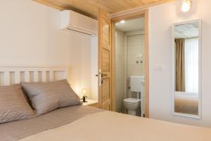 a bedroom with a bed and a bathroom with a toilet at Park Residence in Split