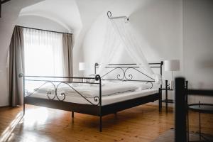 a bedroom with a bed with a canopy at Das Gästehaus in Sankt Veit am Vogau