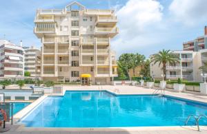 a swimming pool in front of a building at Ona Suites Salou in Salou