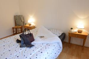 a bedroom with a bed with a bag on it at Le Cerf-Volant in Dieppe