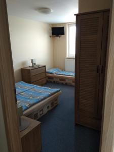 a room with two beds and a television in it at CENTRO in Štúrovo