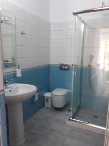 a bathroom with a shower and a toilet and a sink at Beleris Rooms in Himare +46 photos