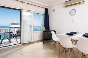 a dining room with a view of the ocean at Promenade Sea View Apartment in Limenas