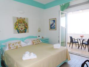 a bedroom with a bed with two towels at Hotel Ossidiana Stromboli Center in Stromboli