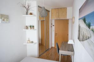 a bedroom with a desk and a table in a room at Cozy apartment btw centre and airport - Private host - No invoice in Bratislava