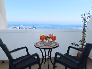a table with two chairs and a view of the beach at Hotel Ossidiana Stromboli Center in Stromboli