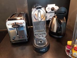 a toaster sitting on top of a counter at L'Echiquier de Normandie confort cosy et vue premium in Rouen