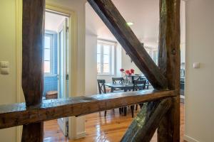 a view of a dining room and living room with a table at MyPlaceLisbon - Mouraria Duplex in Lisbon