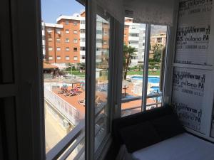 a room with a window with a view of a pool at SALTILLO ALTO WHITE STUDIO in Torremolinos