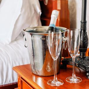 a bucket with a bottle of wine on a table with two glasses at The Queens Hotel in Lytham St Annes