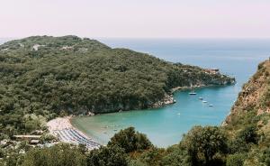 
a large body of water with a beach next to it at San Montano Resort & Spa in Ischia
