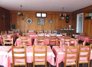 a dining room with pink tables and wooden walls at Hotel Restaurant - Acacias Bellevue in Veyrier-du-Lac