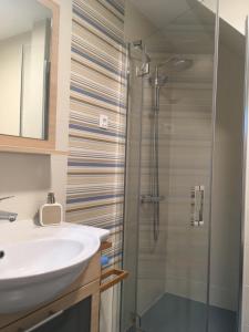 a bathroom with a sink and a shower at Apartment Behin in Martinšćica