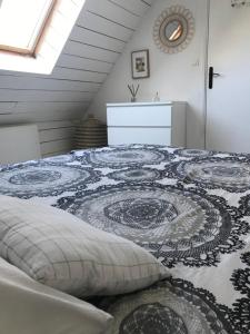 a bedroom with a bed with a rug on it at White and Sea Lodge in Locquirec