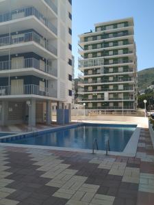 a swimming pool in front of two tall buildings at Descans in Cullera