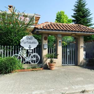 a house with a gate with a bike in front of it at B&B Portobello in Torrevecchia Teatina