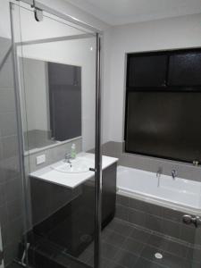 a bathroom with a sink and a bath tub at Near Train Station in Perth