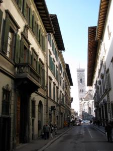 a city street with buildings and a clock tower at Le Tre Stanze in Florence +19 photos
