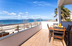 a balcony with a table and a view of the beach at LA CASA DI IRENE in Alghero