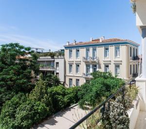 a large white building with trees in front of it at Athens Heritage Suite in Athens