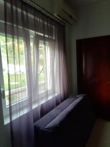 a window with a couch in front of a window at Apartments Marina in Petrovac na Moru