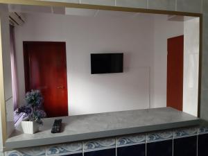 a living room with a television on a wall at Apartments Marina in Petrovac na Moru