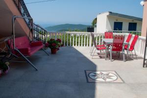 a patio with chairs and a table on a balcony at Apartments Villa Sveti Nikola in Budva