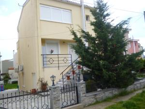 a house with a christmas tree in front of it at Dream House in Iraklitsa
